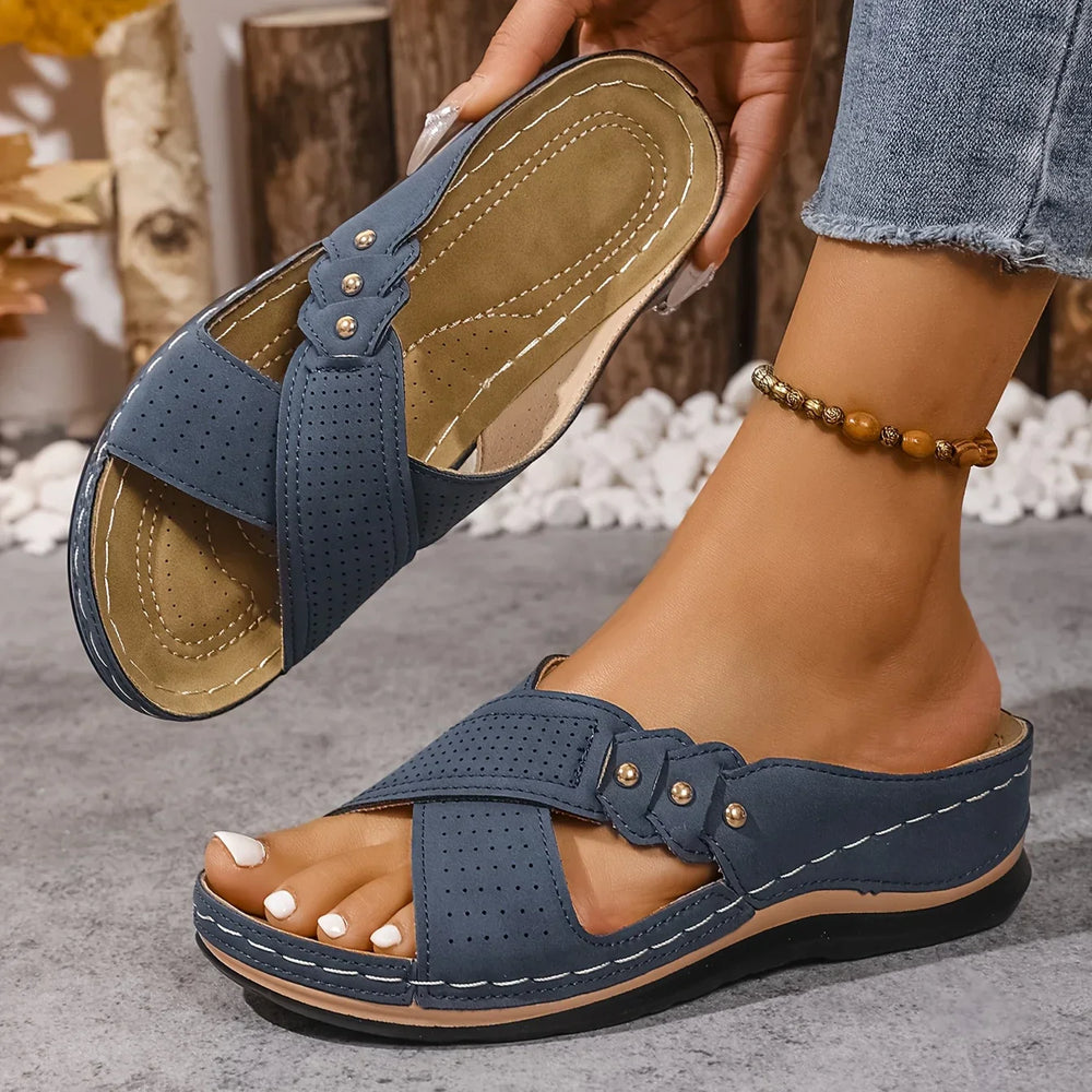 Close-up of women's wedge sandals showing cushioned footbed and contrast stitching detail
