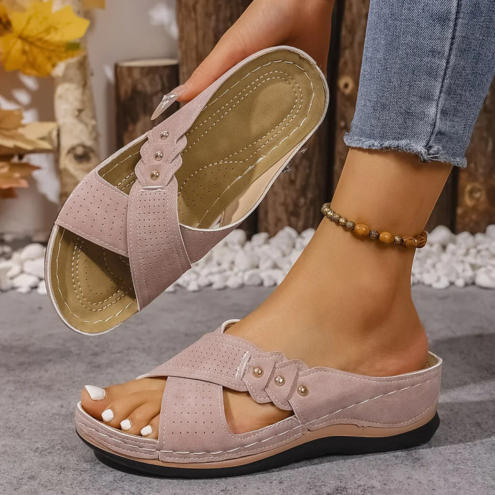 Top-down view of women's wedge sandals highlighting perforated texture and open-toe silhouette
