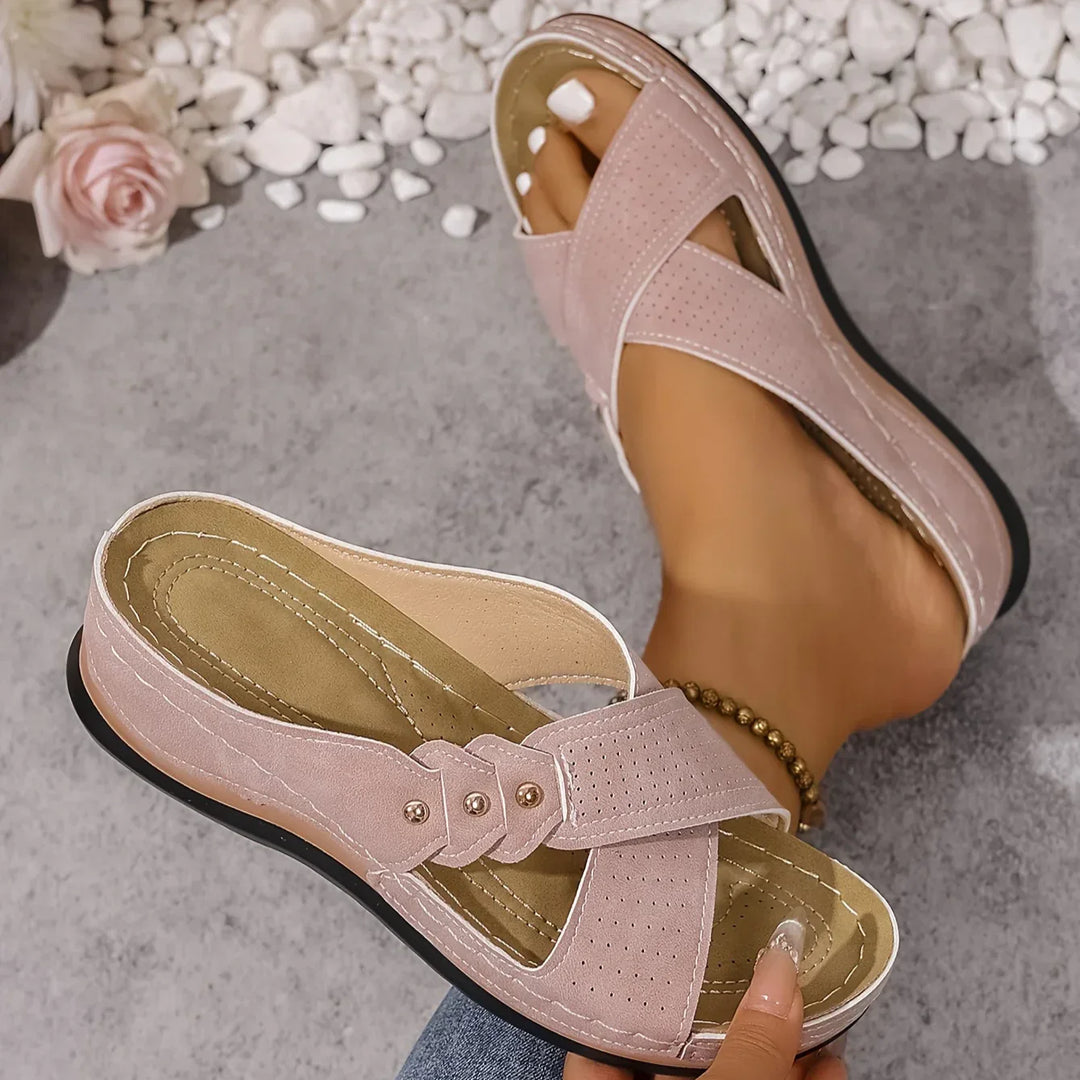 Detail shot of women's wedge sandal footbed showing arch support and beige insole stitching