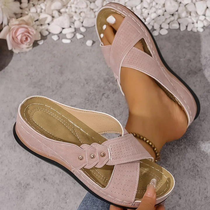 Detail shot of women's wedge sandal footbed showing arch support and beige insole stitching
