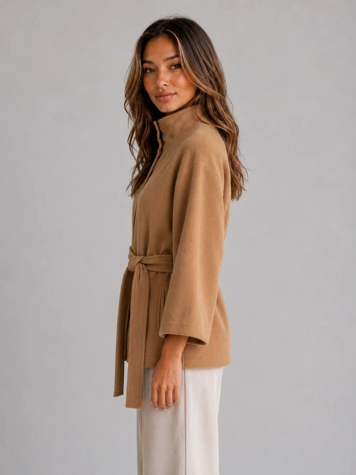 Side angle of women's wrap coat with self-tie belt cinched at waist for flattering silhouette