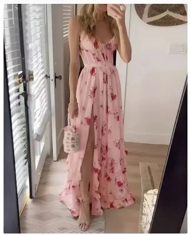 Woman wearing pink floral maxi dress with side slit and slim straps in full-length mirror