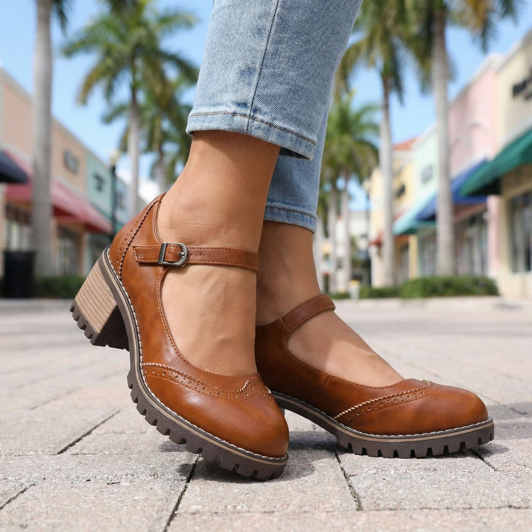 Women's T-strap block heel shoes in brown colourway with brogue detailing and adjustable ankle strap
