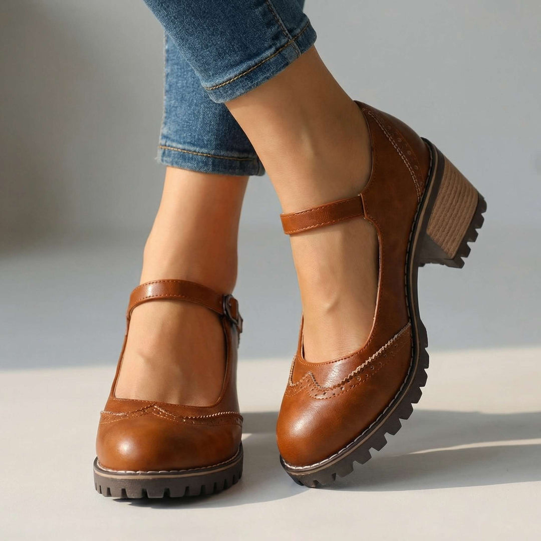 Full view of women's T-strap block heel shoes displaying ankle strap, block heel, and tread sole