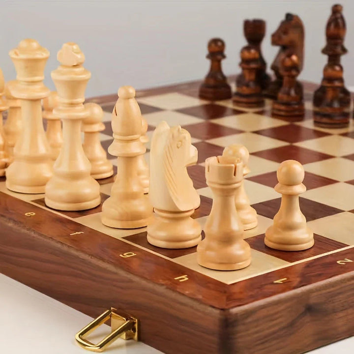 Foldable wooden chess board with brass hinges and coordinate notation along edges for competitive play