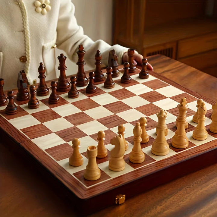 Complete wooden chess set showing all 32 pieces arranged on alternating light and dark wood squares