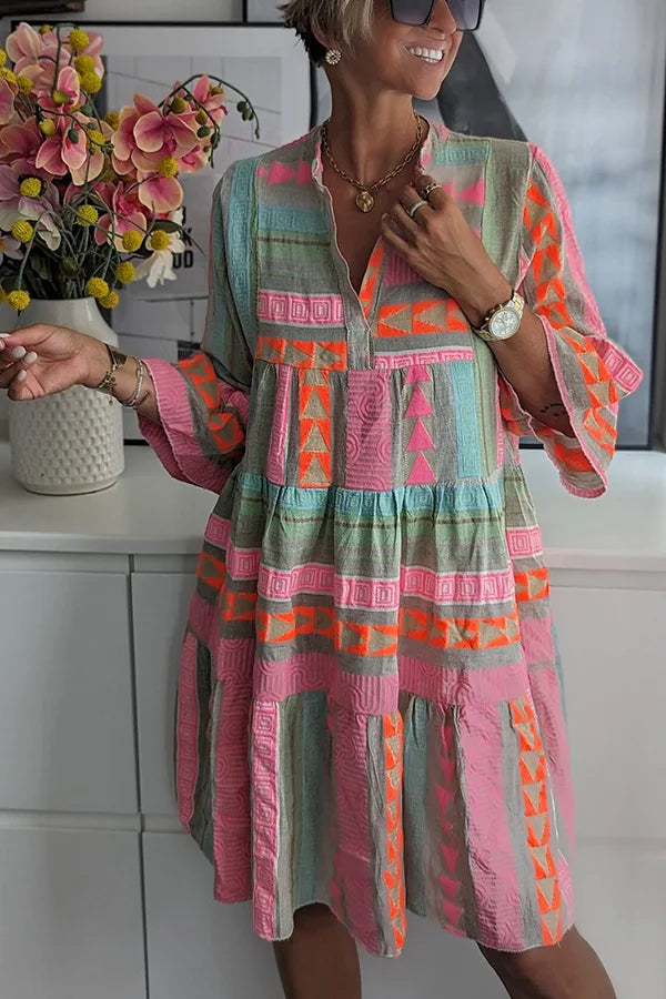 Side view of tiered swing midi dress displaying relaxed silhouette and V-neckline construction