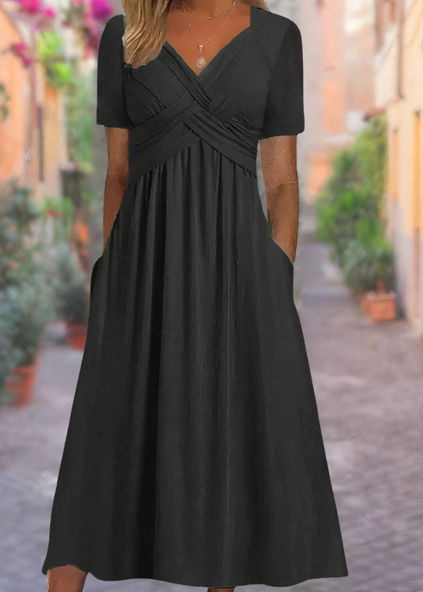 V-neck midi dress with crossover bodice detail and side pockets in flowing A-line silhouette
