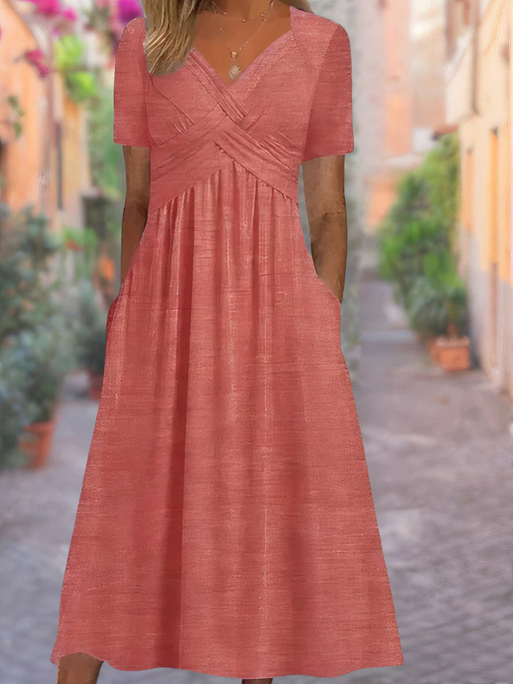 Full-length view of V-neck midi dress with short sleeves and mid-calf hemline