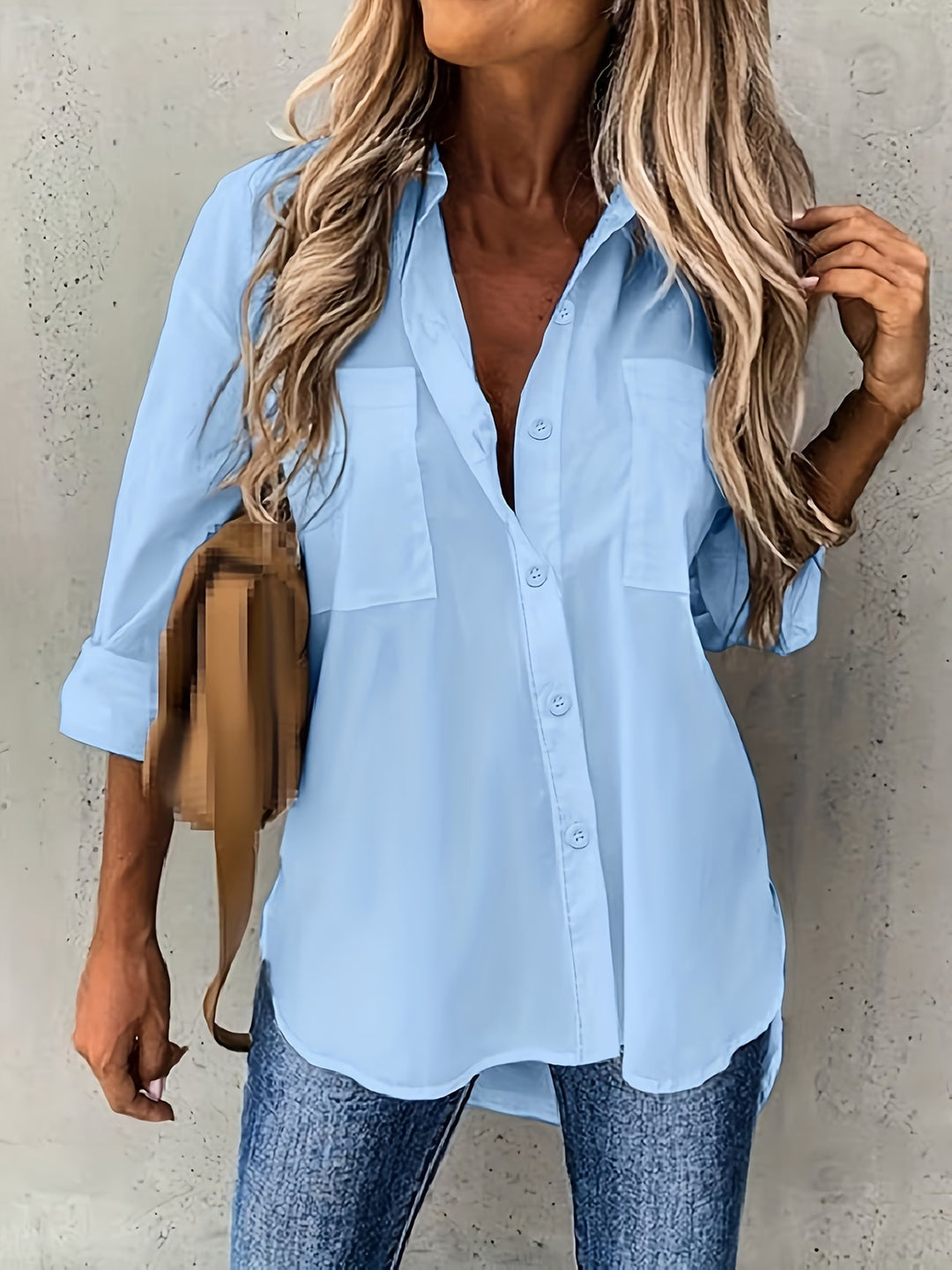 Side view of women's long sleeve shirt with rolled cuffs and curved hem