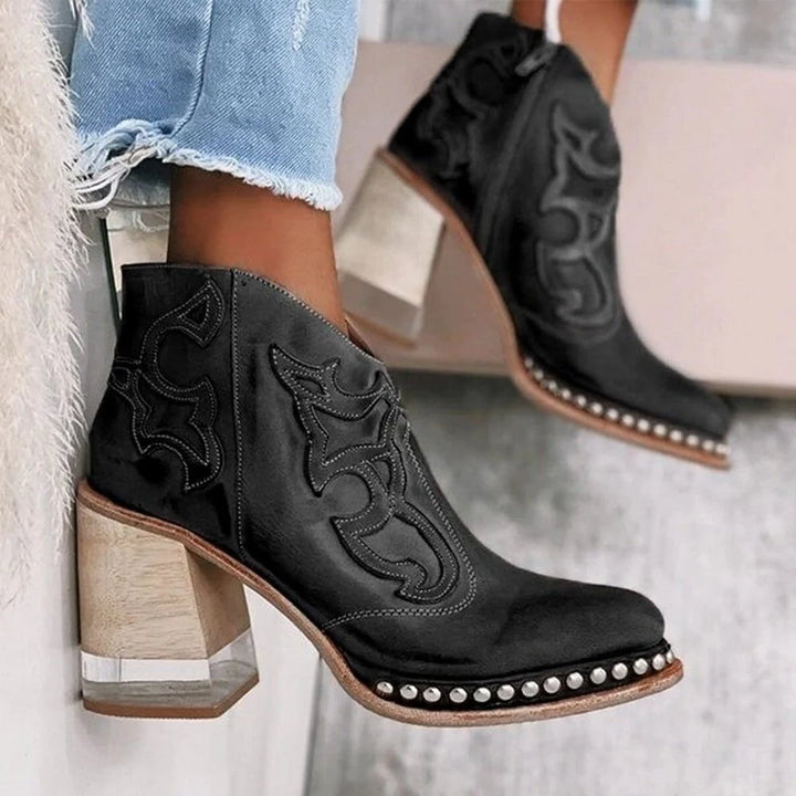 Close-up of embroidered western motif detailing on mid-calf ankle boot shaft with visible topstitching