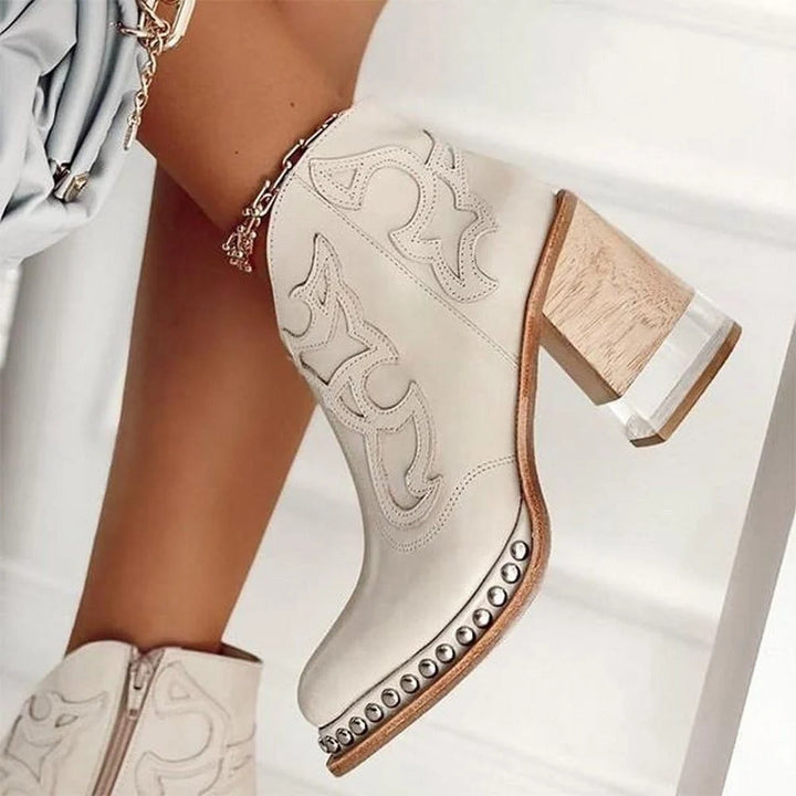 Detail view of block heel construction and embroidered western design on ankle boots
