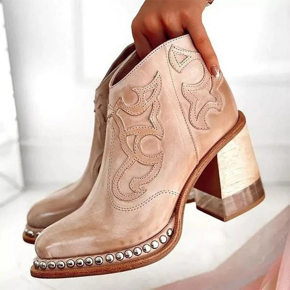Women's embroidered western boots styled with white trousers showing mid-calf height