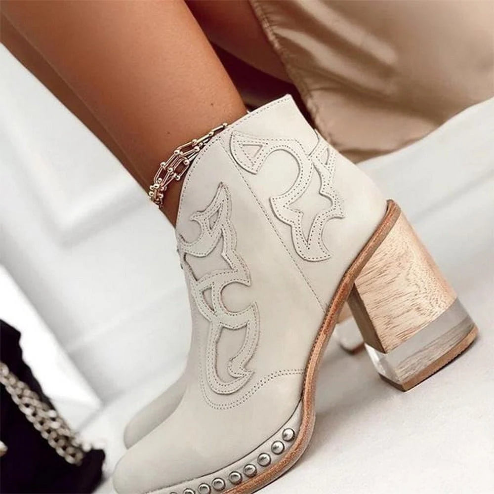 Full view of women's western ankle boots featuring embroidered shaft and studded sole accents