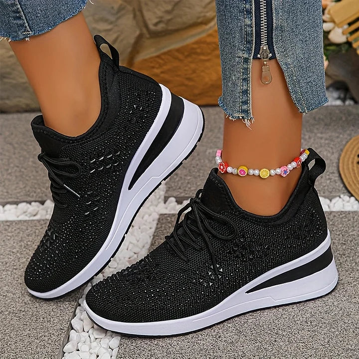 Full view of embellished trainers highlighting cushioned construction and lace-up closure system