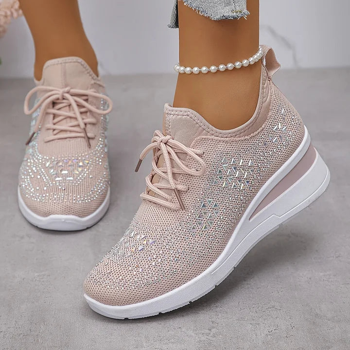 Close-up of structured mesh fabric and rhinestone detailing across trainer upper