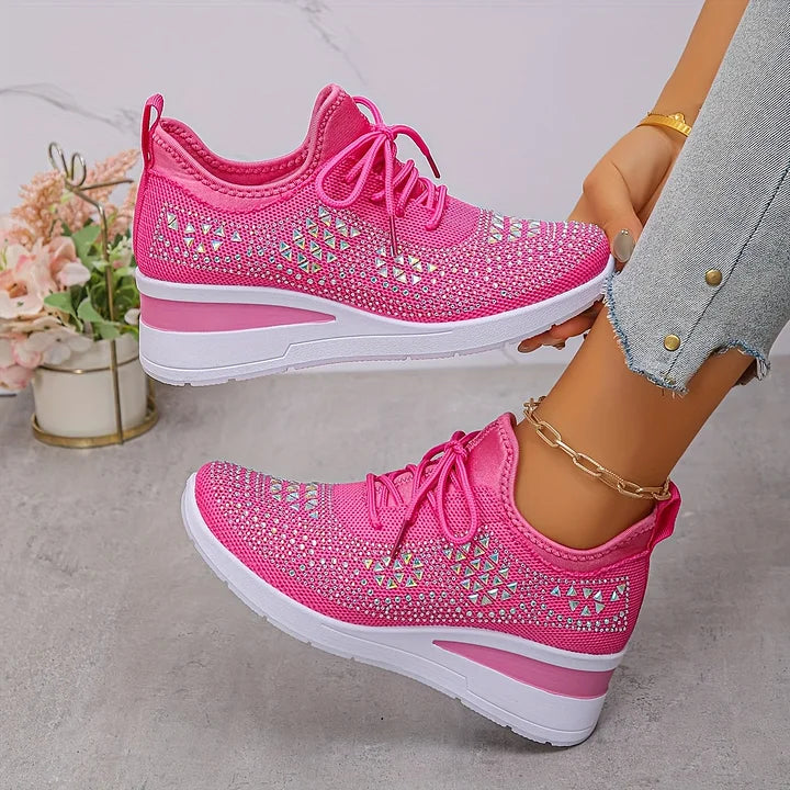 Top-down view of embellished trainers showing lace-up closure and rhinestone pattern across upper
