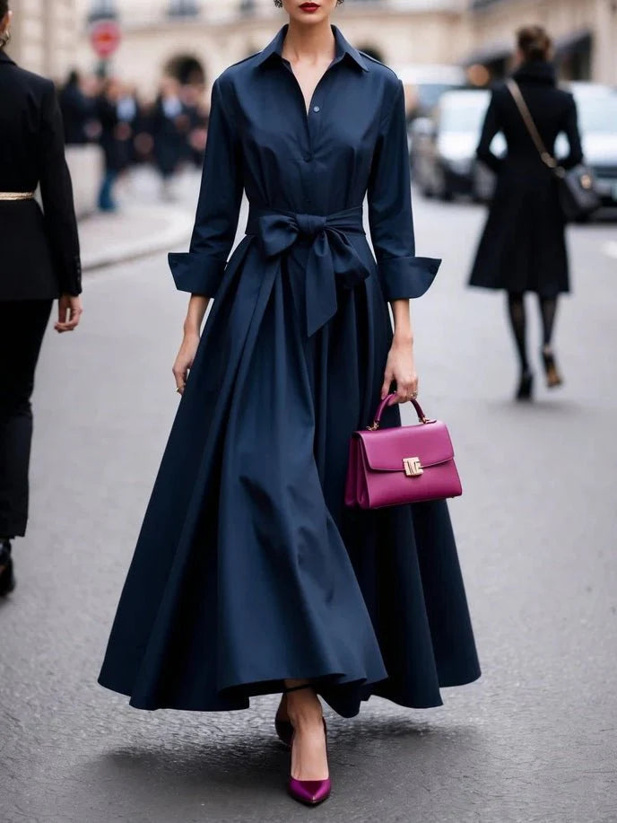 Close-up of women's shirt maxi dress showing button-front closure and adjustable tie waist detail