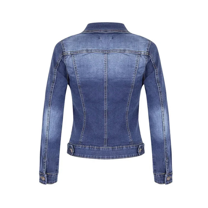 Detail shot of chest pocket and button closure on women's short denim casual jacket