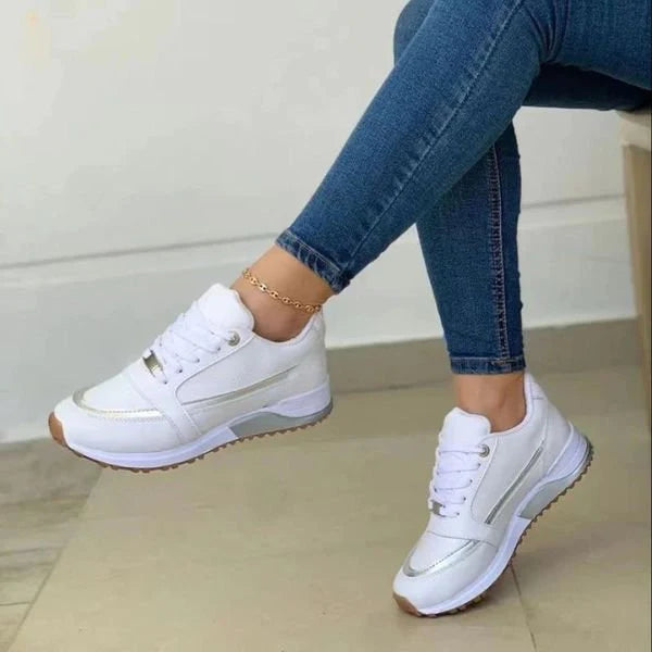 Close-up view of women's lace-up trainers showing supportive footbed and padded collar design
