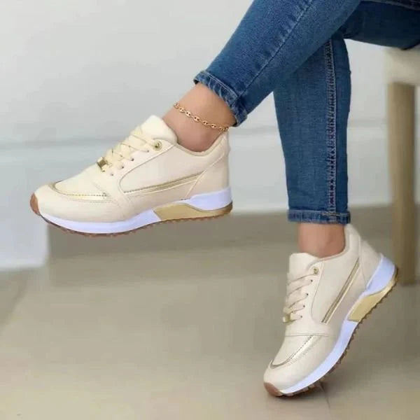 Side profile of women's navy trainers featuring breathable upper and white midsole cushioning