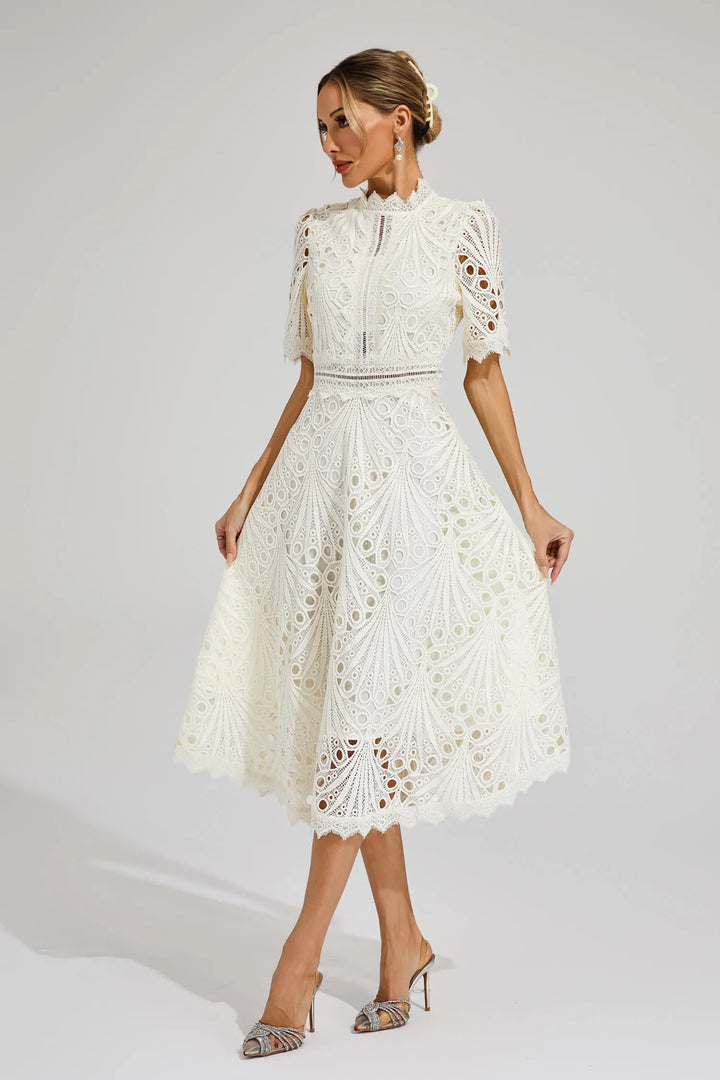 Woman wearing white lace midi dress with high neckline and intricate openwork detailing for weddings