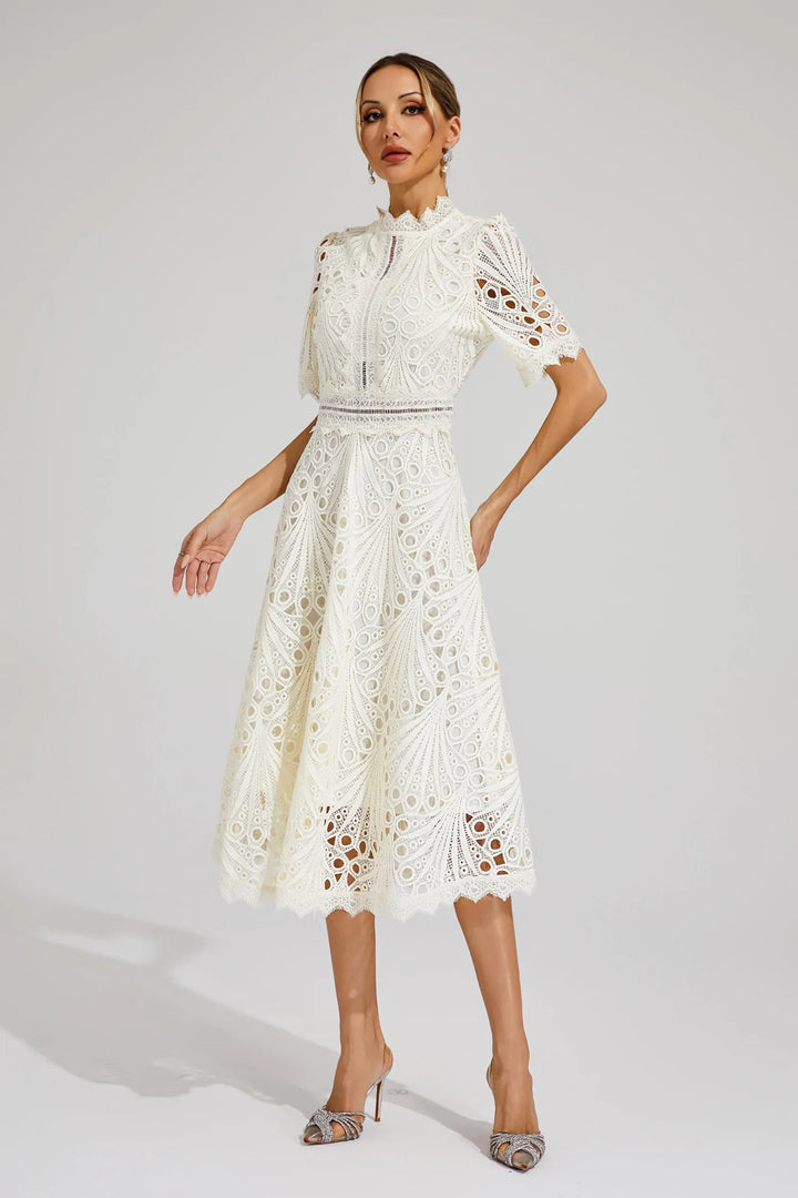 Woman in white lace midi dress styled for formal daytime event or celebration