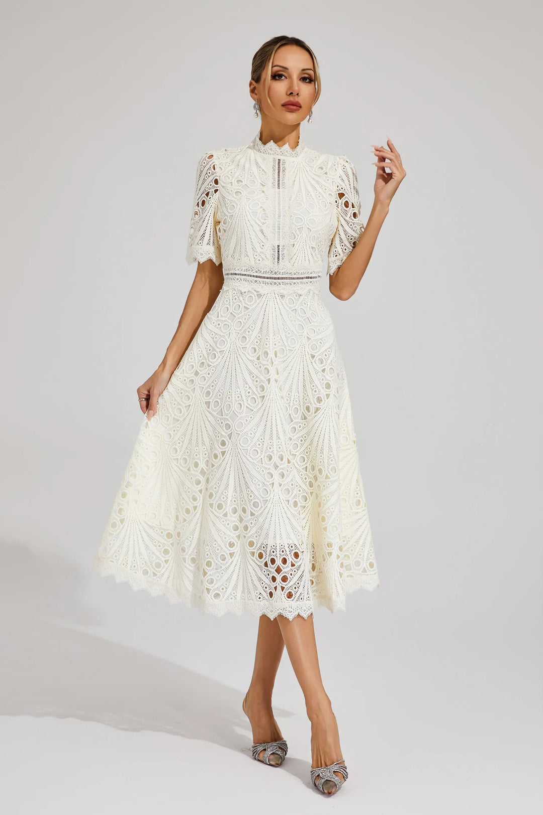 Detail of waistline and skirt drape on structured lace midi dress