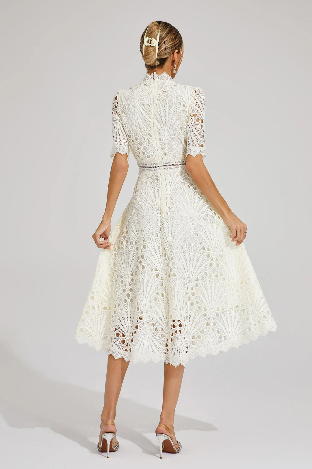 Woman wearing lace midi dress with statement earrings for special occasion