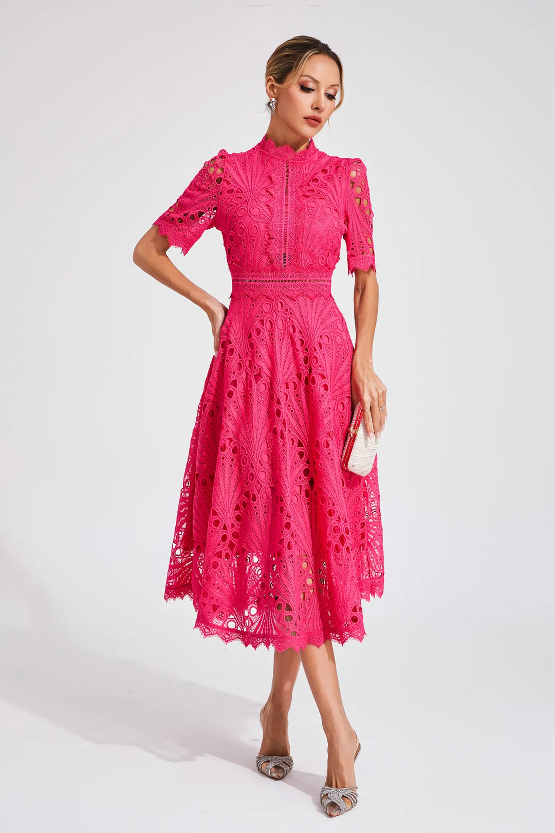 Back view of white lace midi dress with fitted waist and knee-length hem