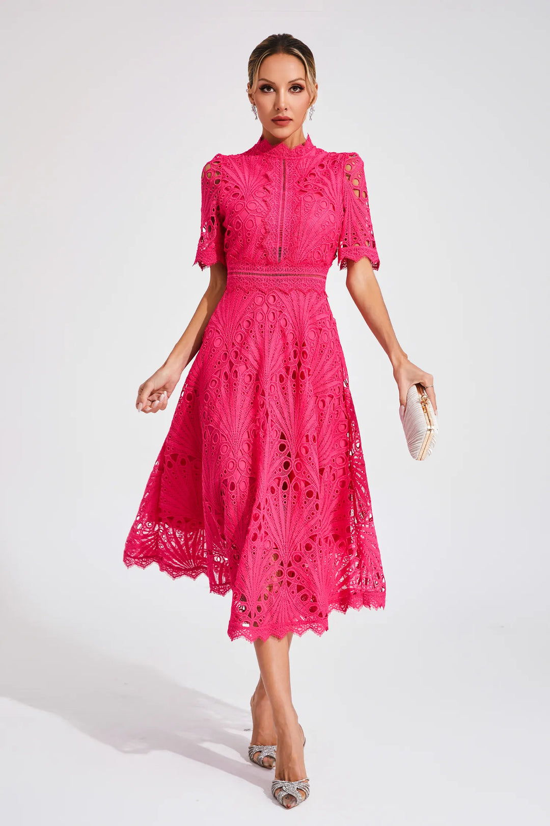 Detail of high neckline and structured openwork fabric on lace midi dress