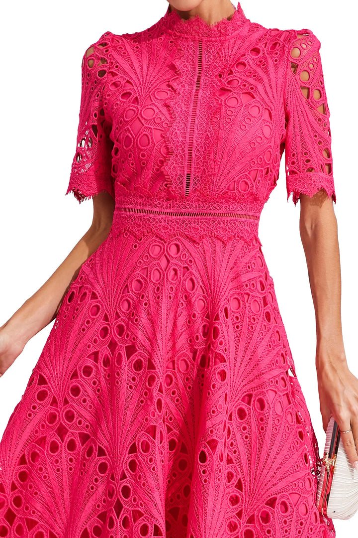 Close-up of decorative lace pattern and fitted bodice on midi dress