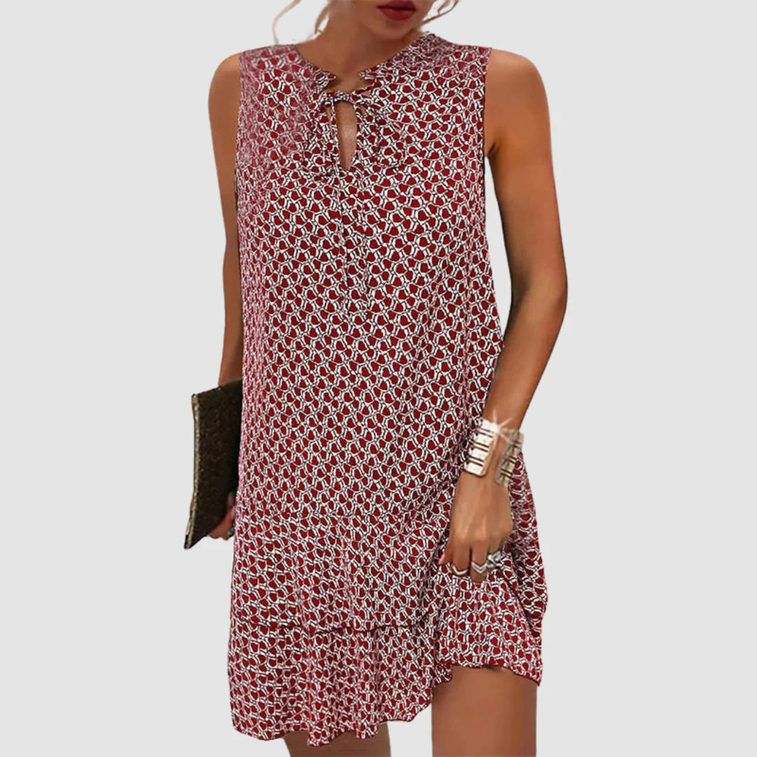 Close-up view of printed shift dress showing all-over geometric pattern and sleeveless design detail
