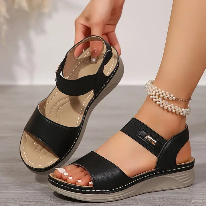 Close-up view of women's orthopedic sandals showing adjustable double-strap design with hook-and-loop closures and cushioned insole for comfort support
