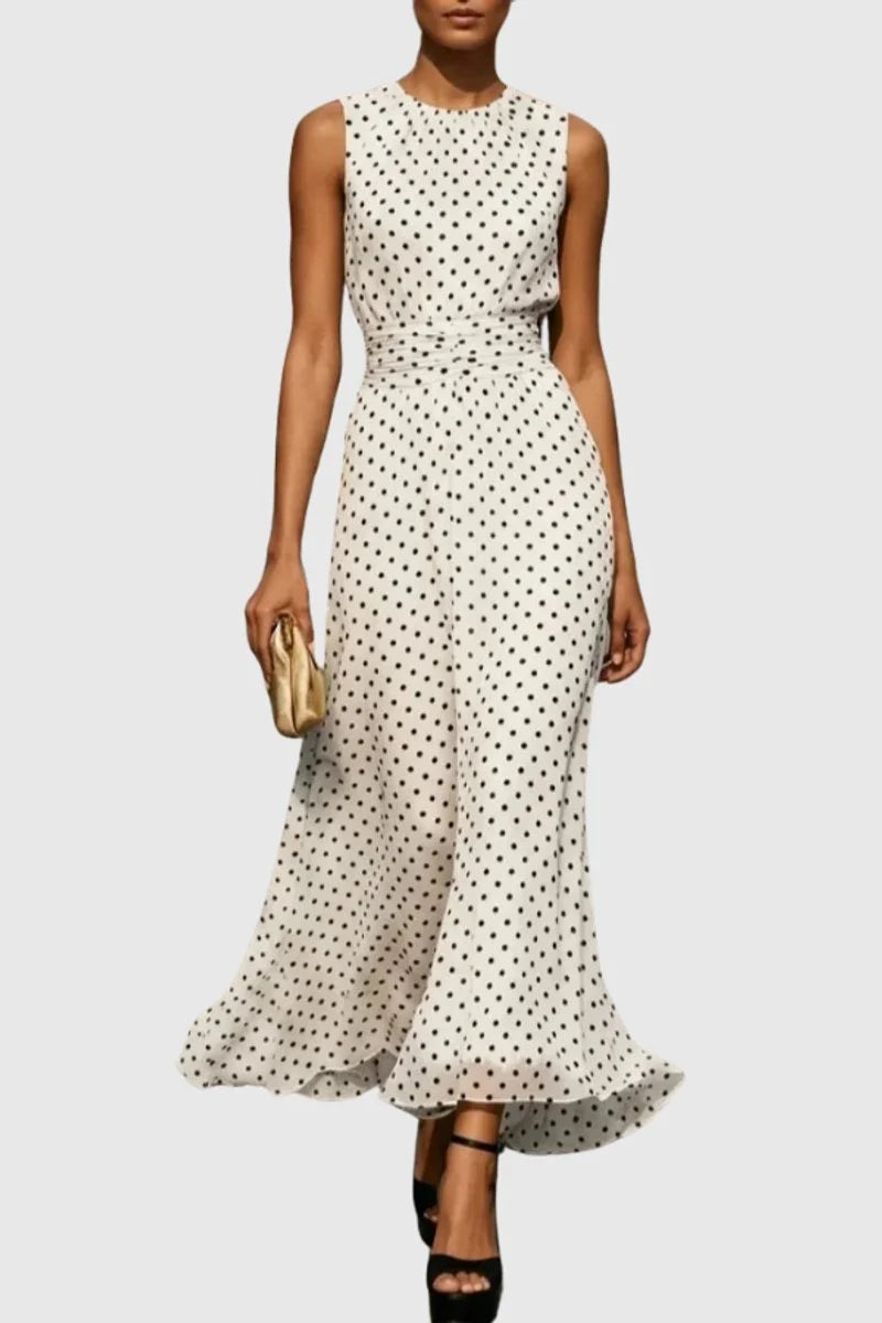 Polka dot sleeveless maxi dress with cinched waist and ruffle hem in cream with black dots