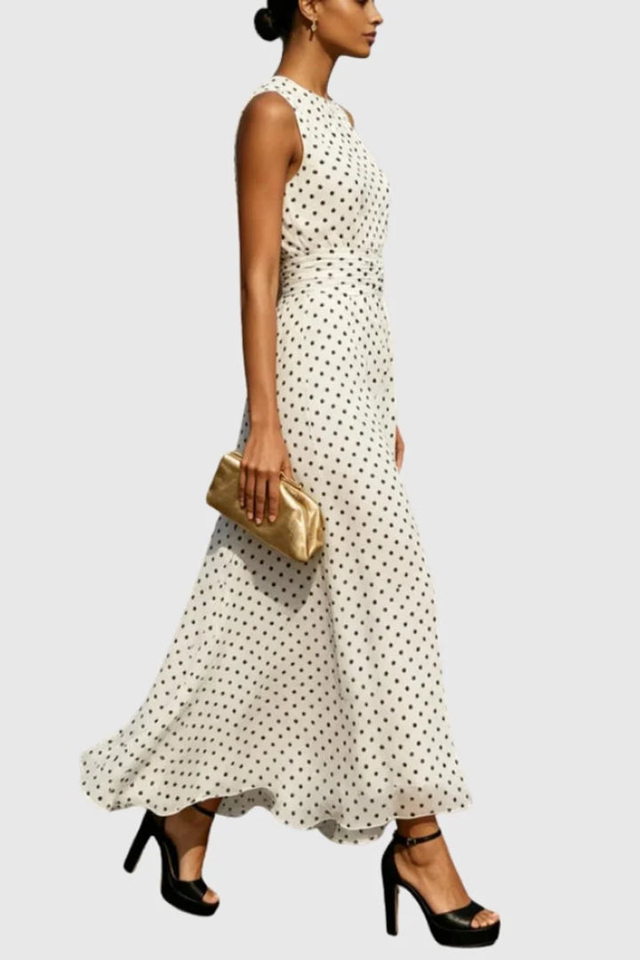 Side view of polka dot sleeveless maxi dress with cinched waist detail