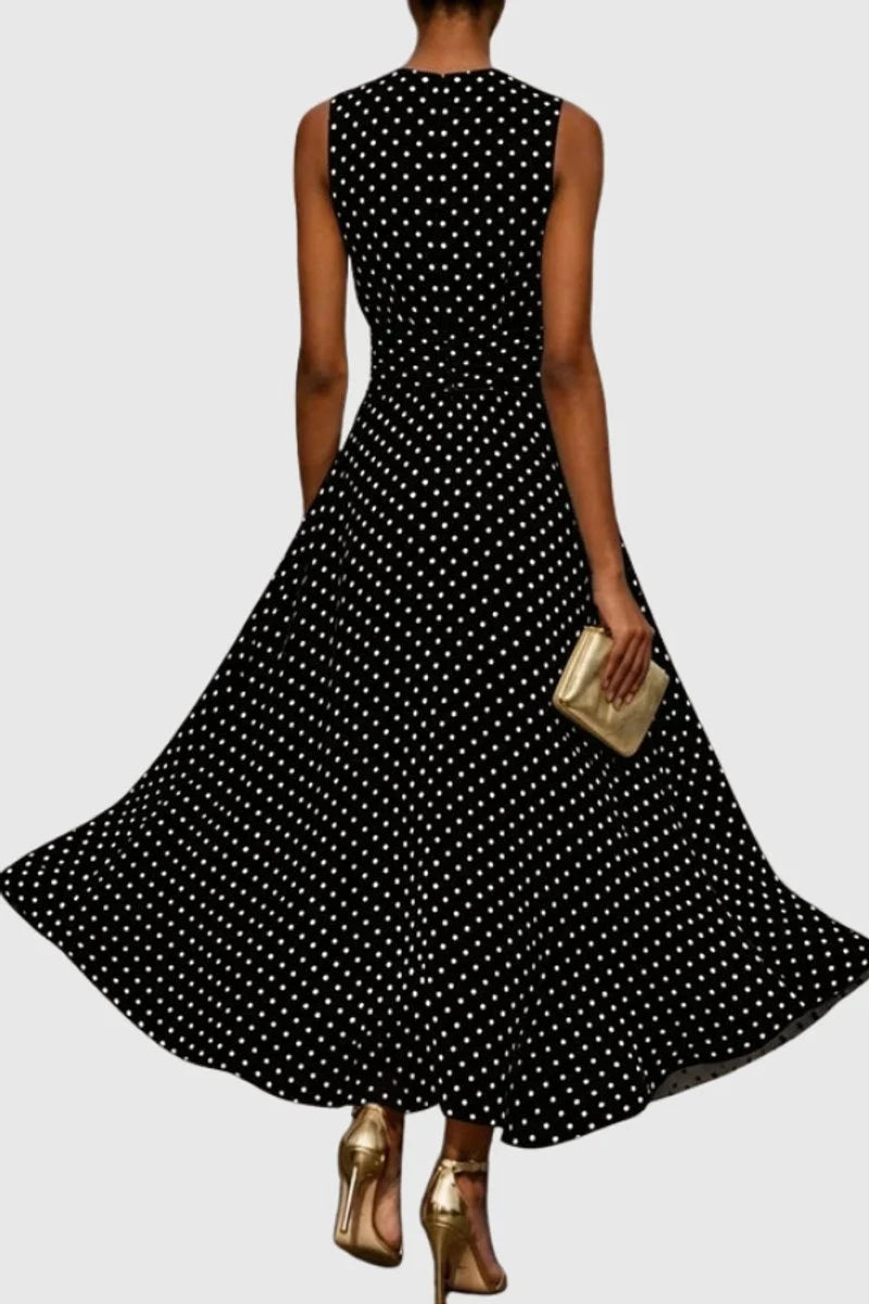 Close-up of ruffle hem detail on polka dot maxi dress