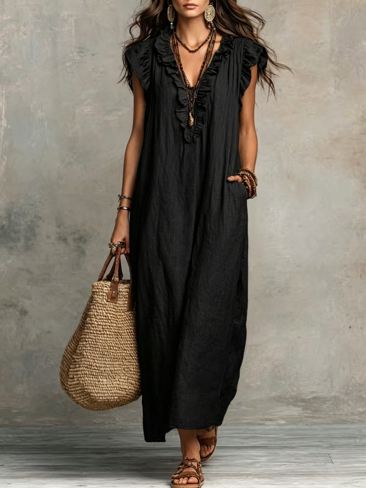 Side view of relaxed fit maxi dress with cap sleeves and flowing hem