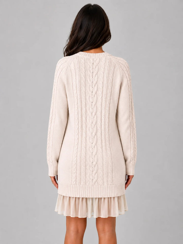Front view of cable knit jumper mini dress showing crew neckline, long sleeves, and integrated pleated hem