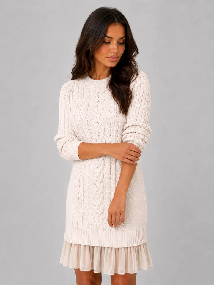 Close-up of cable knit pattern and pleated hem detail on women's mini jumper dress