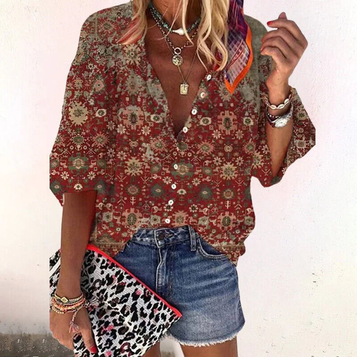 Side view of women's floral print blouse showing flowing three-quarter sleeve and relaxed drape