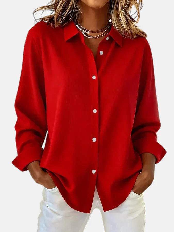 Side view of women's oversized pink shirt displaying dropped shoulder seam and loose drape through body
