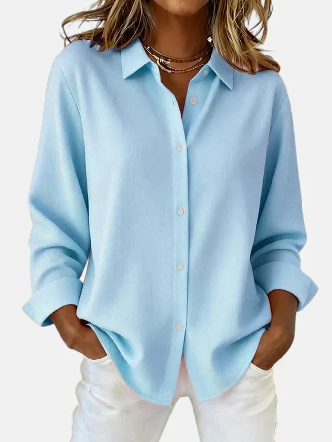 Detail of women's oversized pink shirt collar and button placket with smooth woven fabric finish