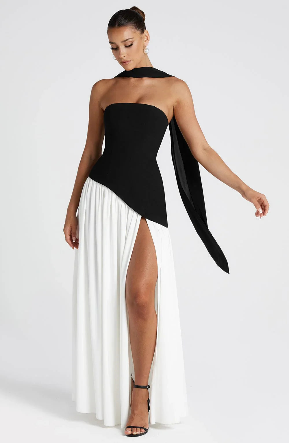 Close-up view of the structured strapless bodice and asymmetric waistline detail on the maxi dress