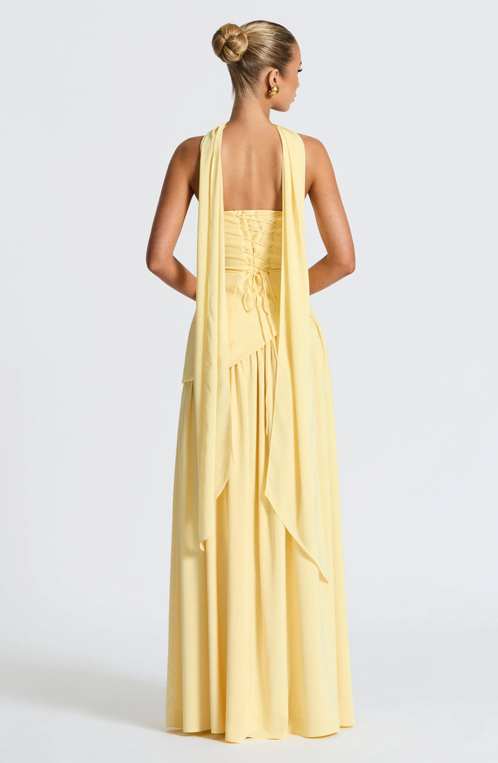 Movement shot showing the high slit and drape of the full-length skirt