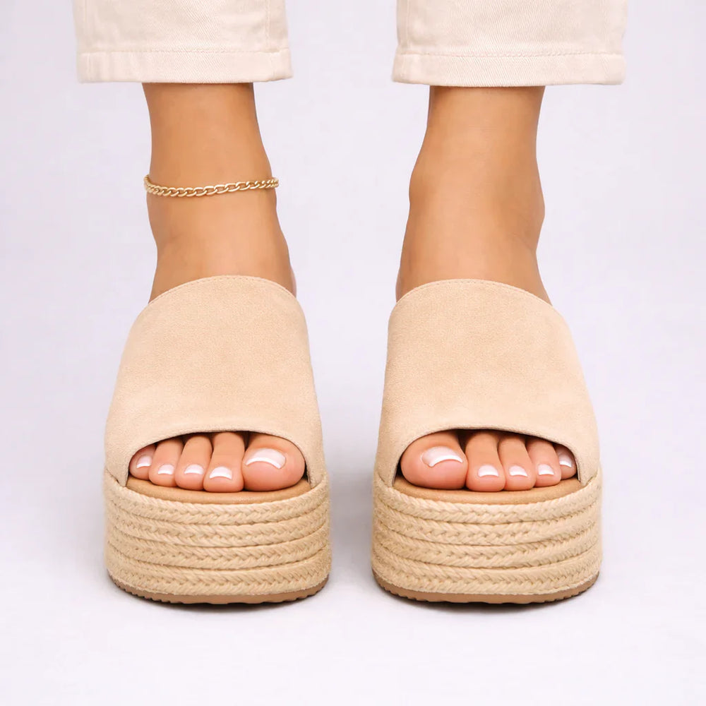 Close-up view of women's espadrille wedge sandals showing jute-wrapped platform and wide upper band