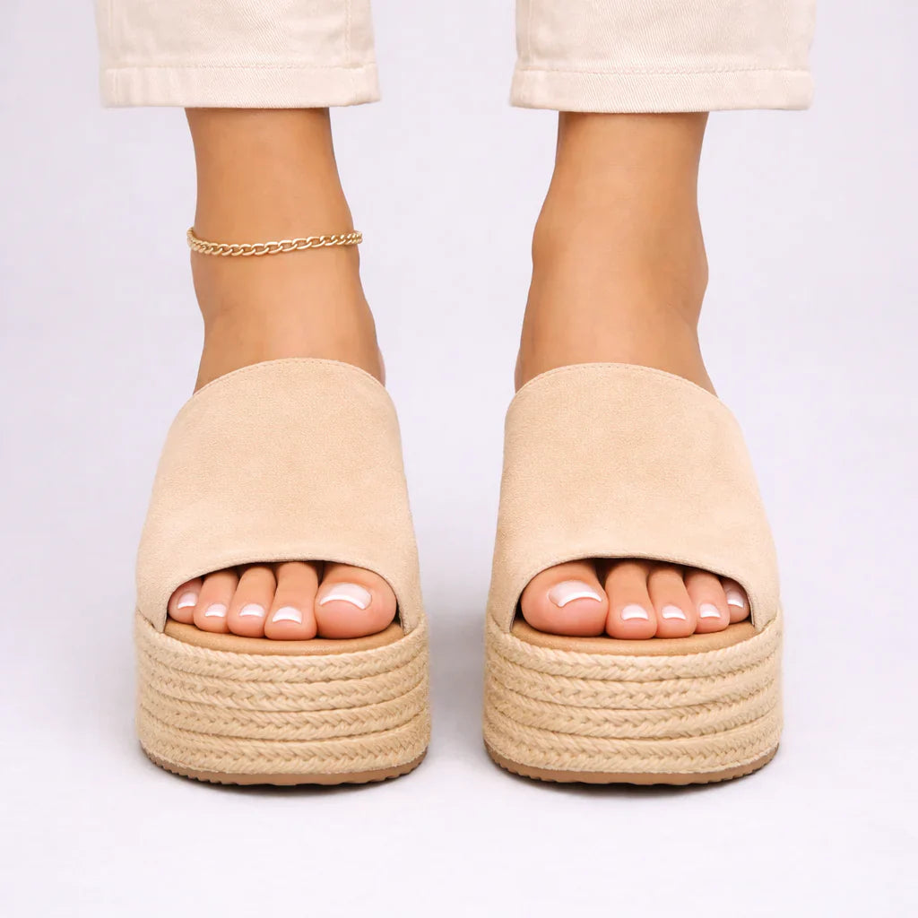 Close-up view of women's espadrille wedge sandals showing jute-wrapped platform and wide upper band