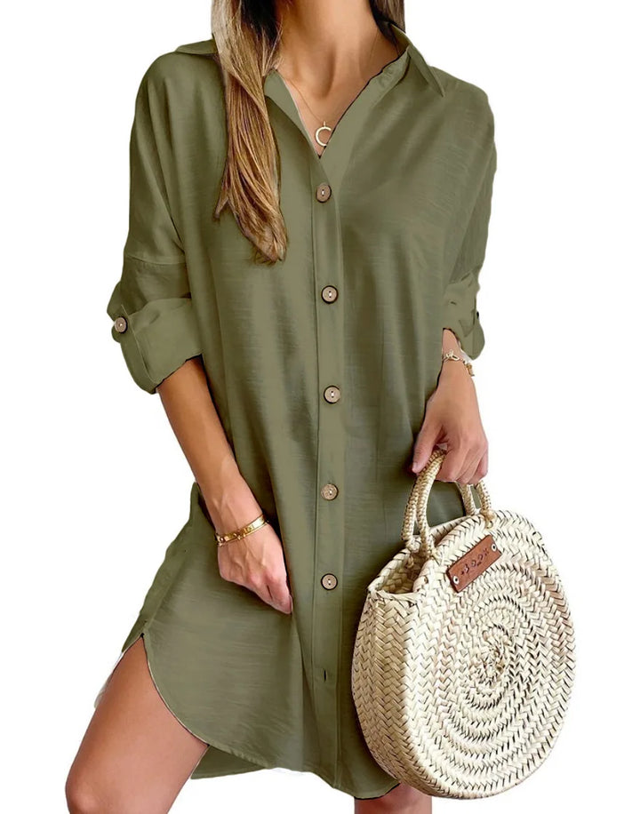 Detail of roll-tab sleeve and button fastening on linen shirt dress