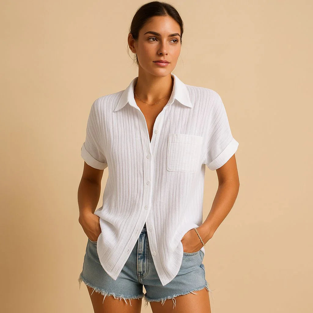 Close-up of women's relaxed shirt showing rolled cuff sleeves and chest pocket detail