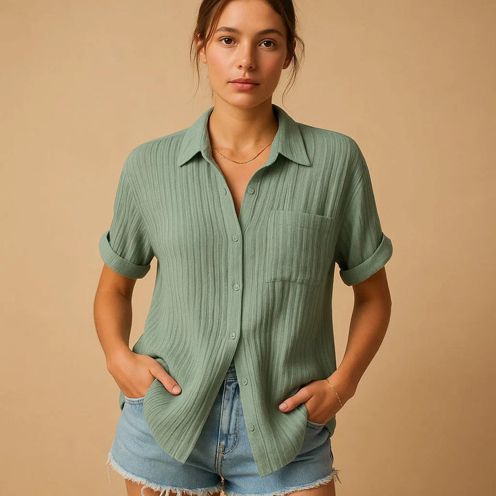 Detail shot of women's relaxed shirt collar and button-through front with chest pocket
